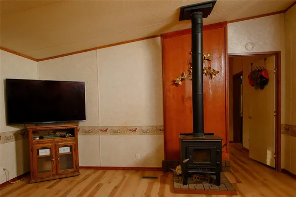 a view of room with wooden floor and furniture