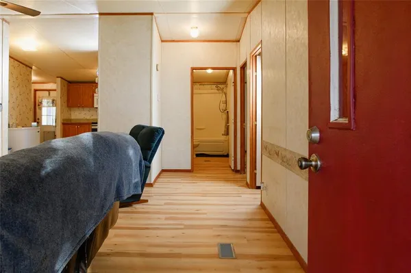 a view of a hallway with wooden floor and staircase
