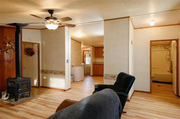 a spacious bedroom with a bed and wooden floor