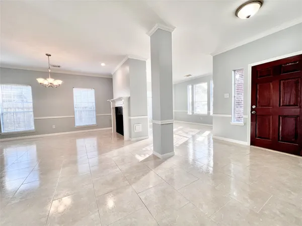 a big room with chandelier and windows