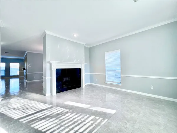 a view of a livingroom with wooden floor and kitchen space with a sink