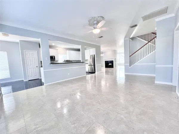a view of kitchen with kitchen island wooden floor and stainless steel appliances