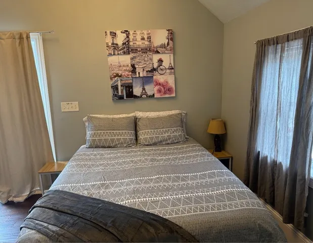 a bedroom with a bed and a window