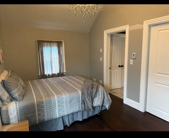 a bed sitting in a bedroom next to a bathroom