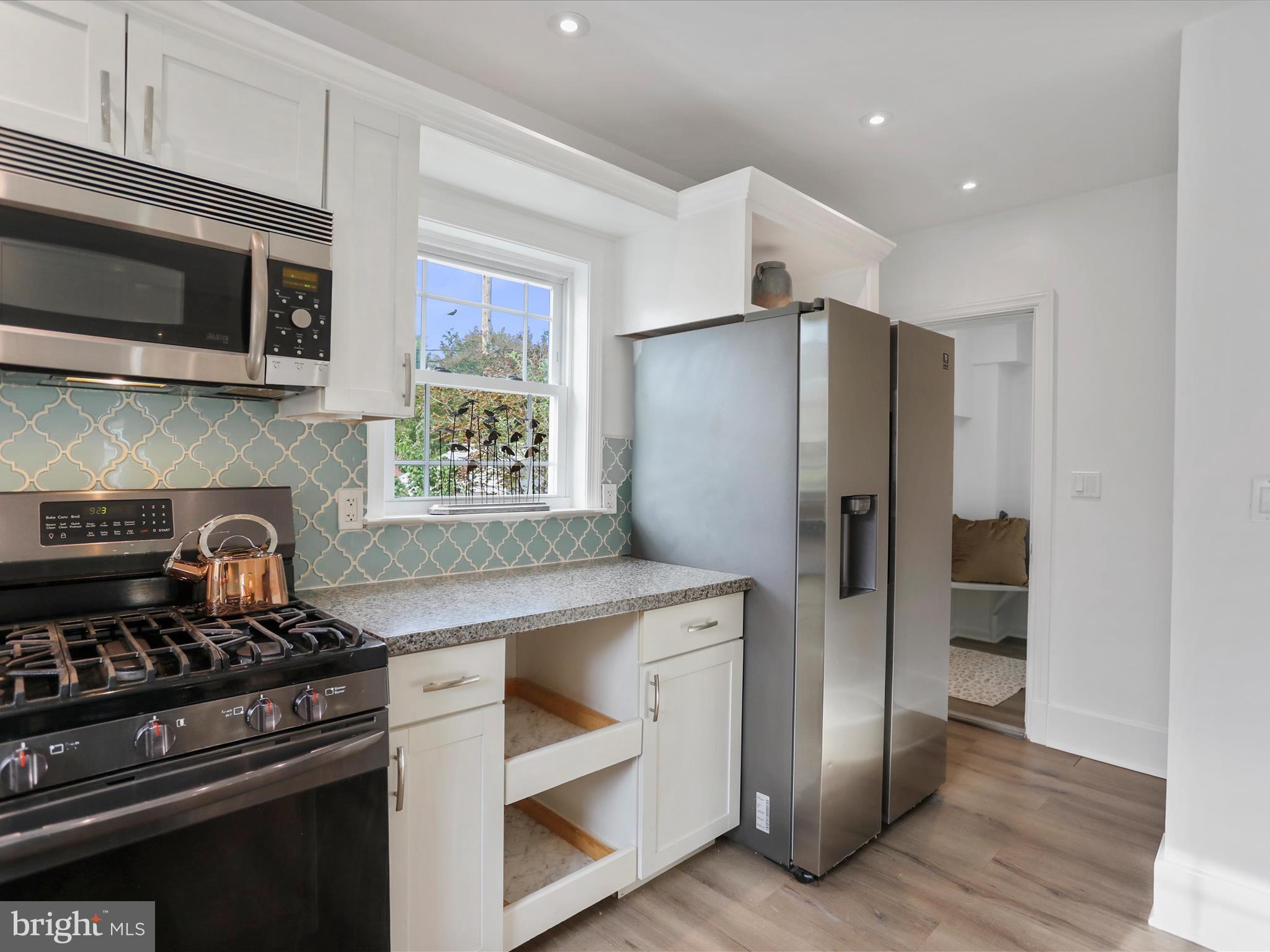 102 Frederick Avenue Frederick, MD 21701 - Photo 11 of 55 a kitchen with stainless steel appliances granite countertop a stove and a refrigerator