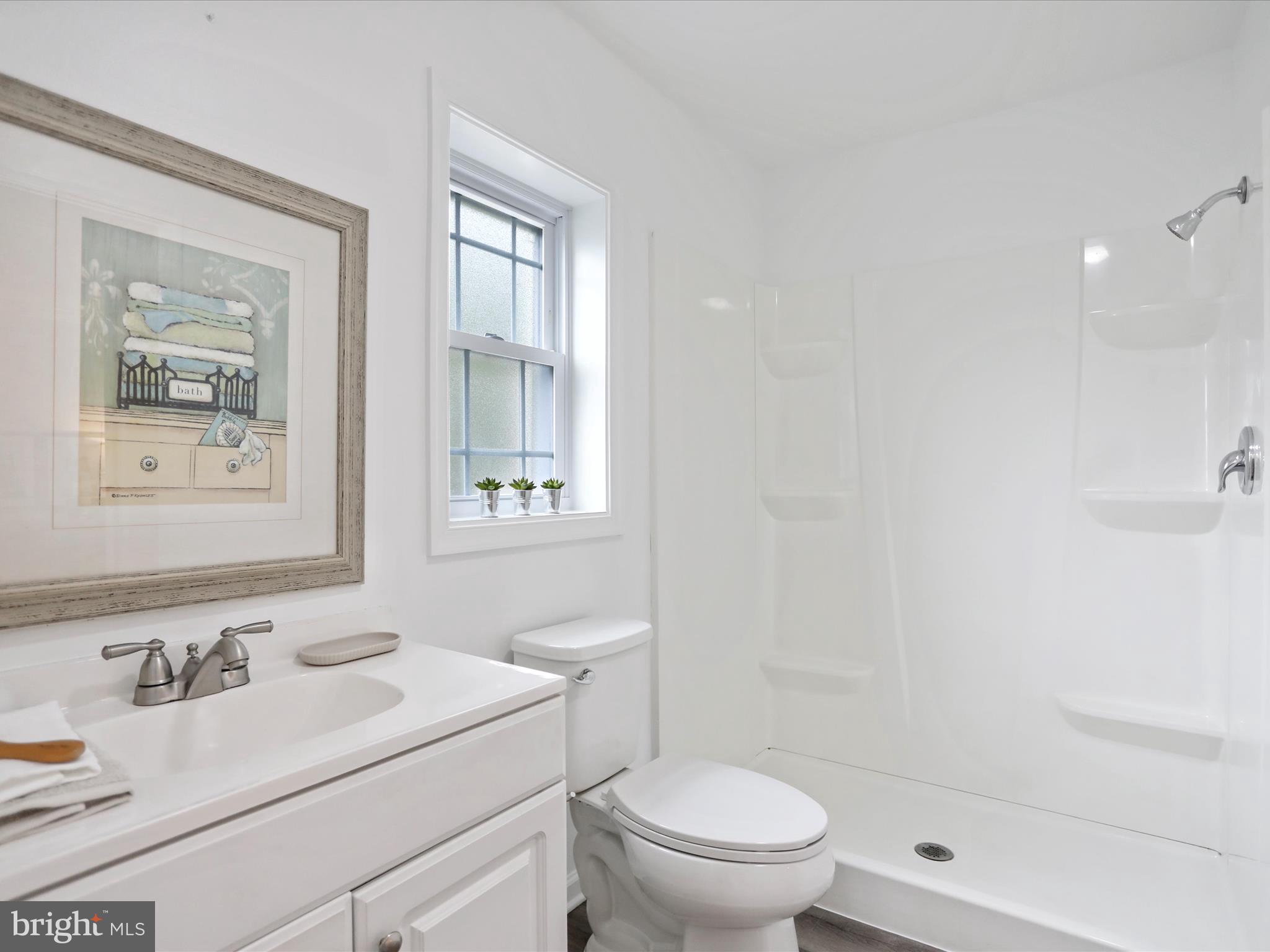 102 Frederick Avenue Frederick, MD 21701 - Photo 13 of 55 a bathroom with a sink a toilet and a mirror