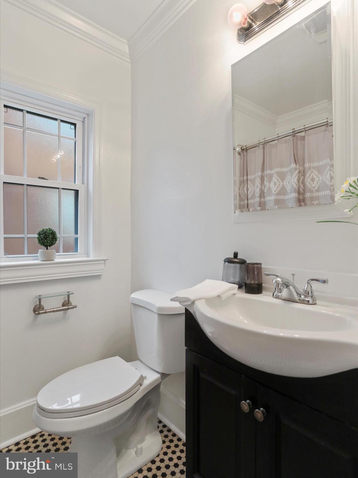 102 Frederick Avenue Frederick, MD 21701 - Photo 18 of 55 a bathroom with a sink a toilet and a mirror
