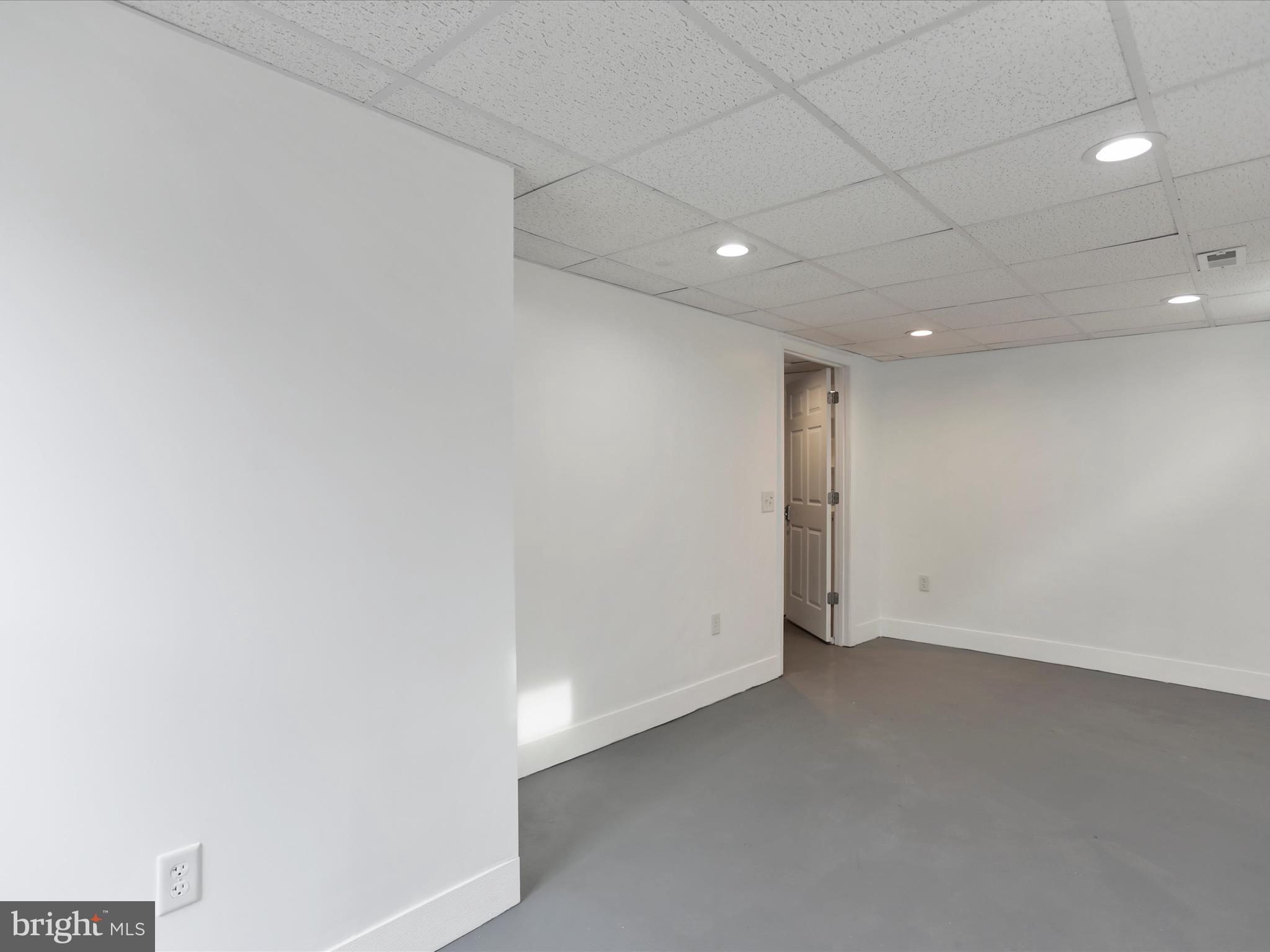 102 Frederick Avenue Frederick, MD 21701 - Photo 41 of 55 an empty room with a empty space and windows