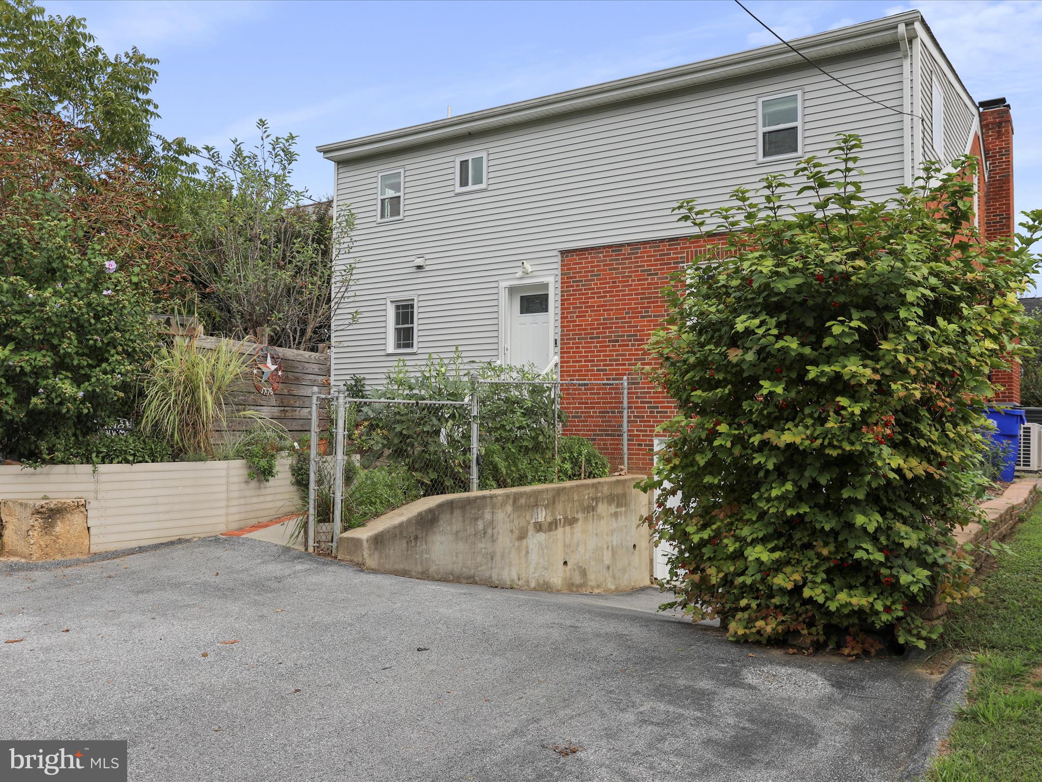 102 Frederick Avenue Frederick, MD 21701 - Photo 44 of 55 a backyard of a house with plants and trees