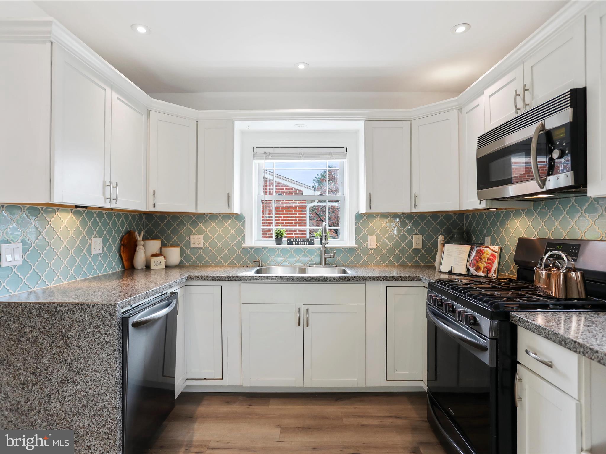 102 Frederick Avenue Frederick, MD 21701 - Photo 10 of 55 a kitchen with stainless steel appliances granite countertop a sink stove and microwave