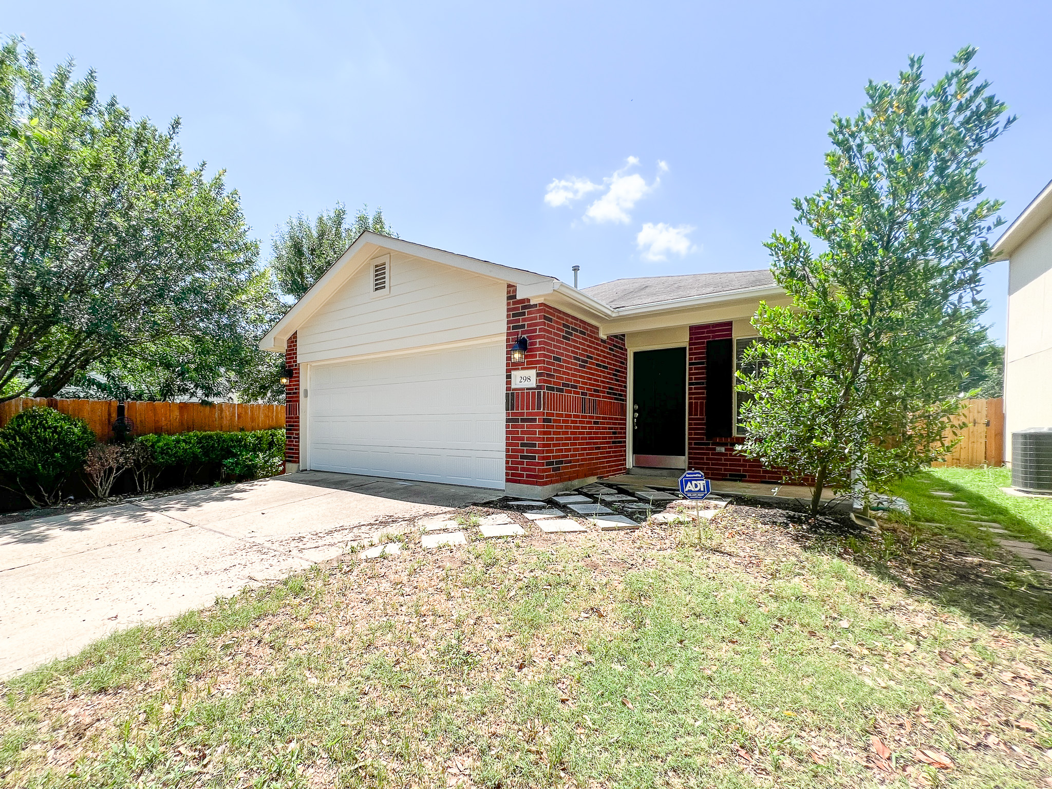 298 Jack Rabbit Lane Buda, TX 78610 - Photo 20 of 24 A classic brick exterior and white garage door welcome you home.
