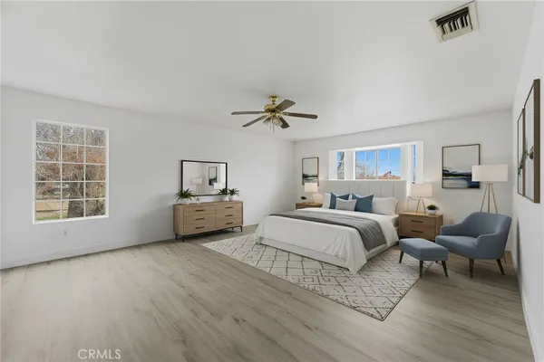a spacious bedroom with a bed and a window