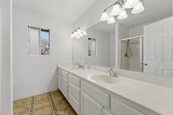 a bathroom with a double vanity sink and a mirror