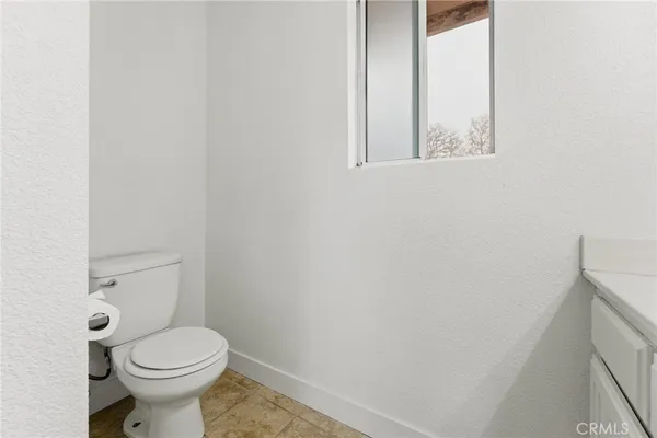 a white toilet sitting next to a white sink