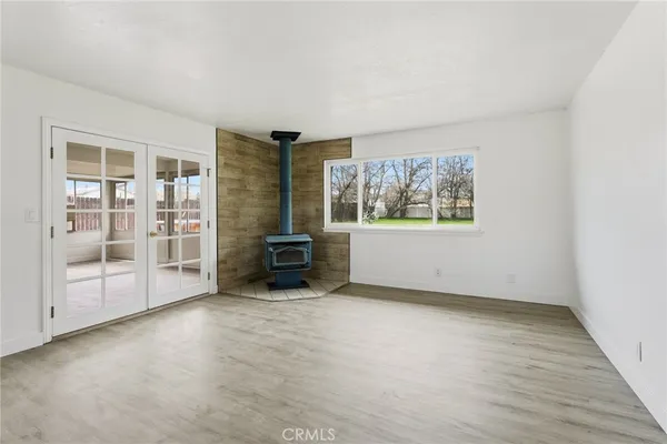 an empty room with furniture and windows