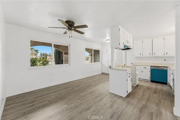 a kitchen with kitchen island a white cabinets and window