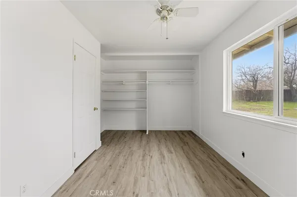 a view of room with window and wooden floor