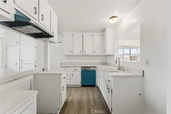 a kitchen with a sink a stove and cabinets