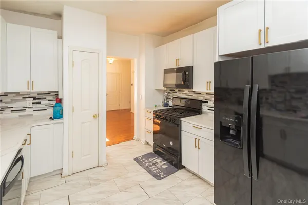 a kitchen with a refrigerator a stove top oven a sink and dishwasher