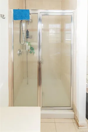 a bedroom with a bed window and a chandelier