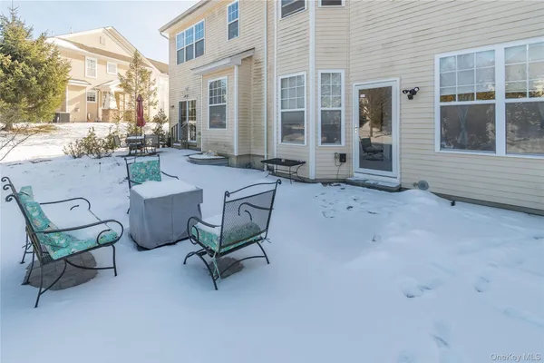 a backyard of a house with a couch and chairs
