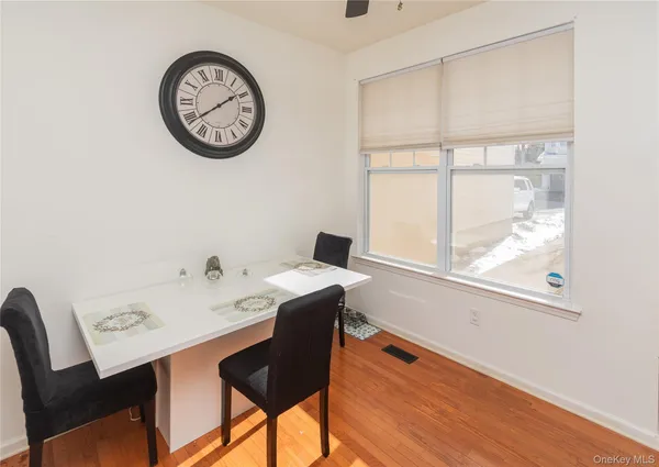 a view of a workspace with a table and a chair