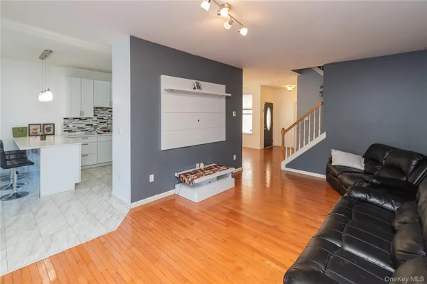 a bedroom with furniture and a wooden floor