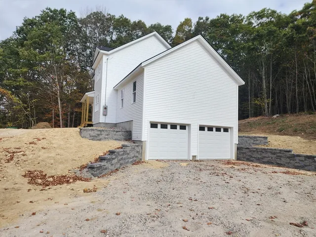 a view of a white house with a yard covered in snow