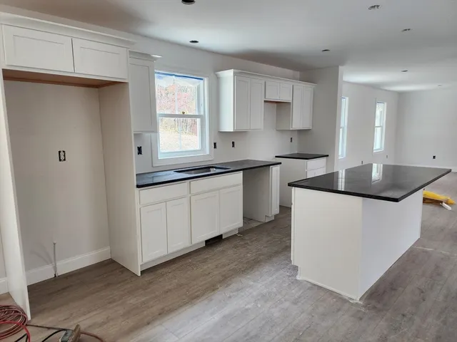 a kitchen with sink and cabinets