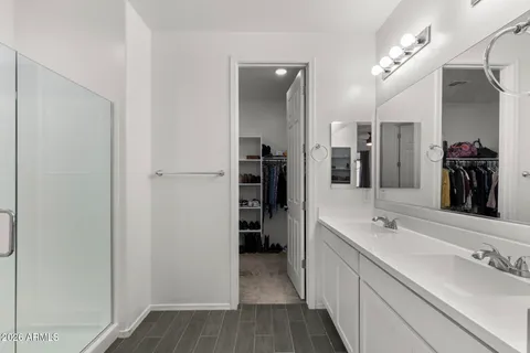 a spacious bathroom with a double vanity sink and a mirror