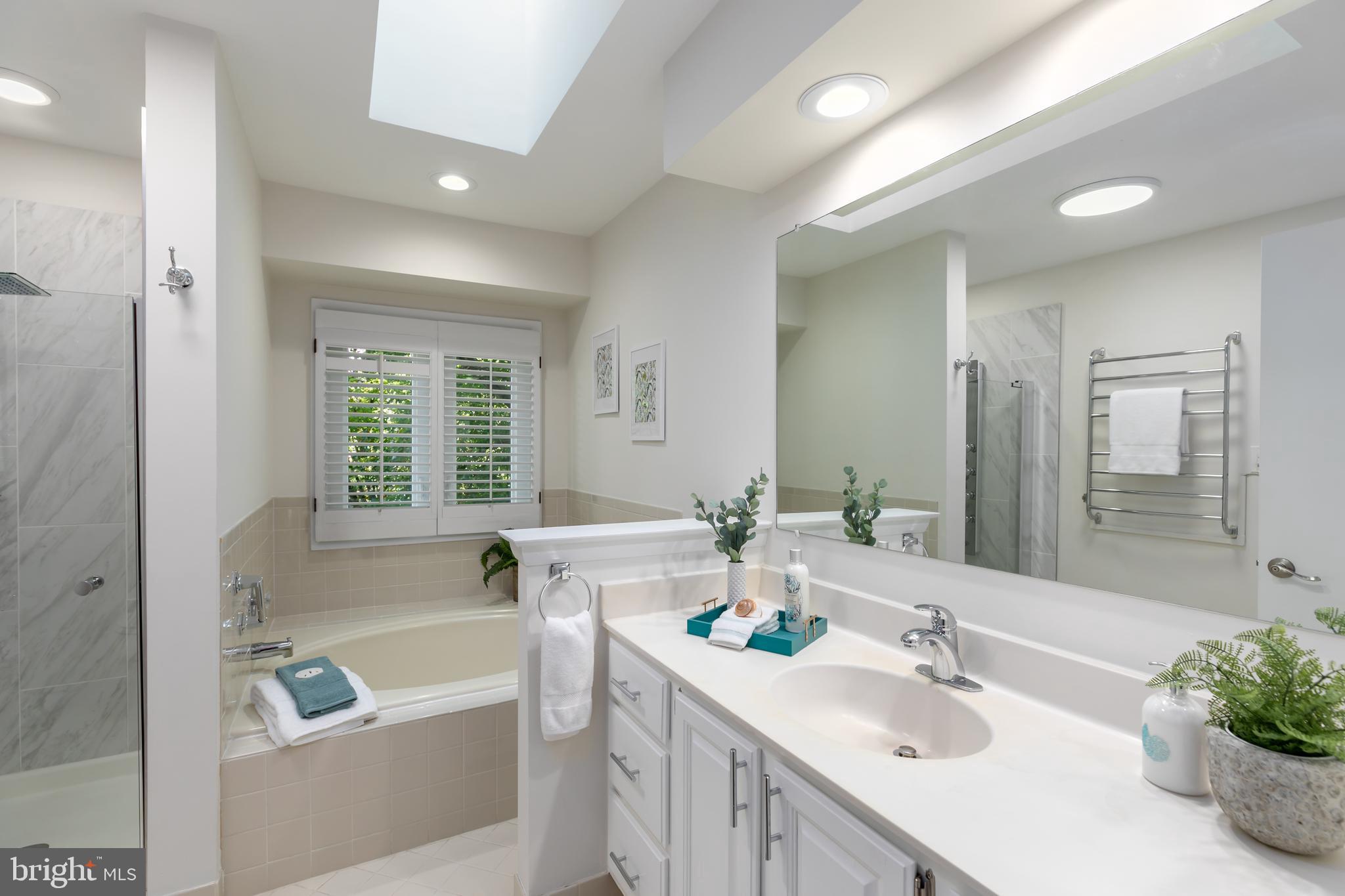 11554 Brass Lantern Court Reston, VA 20194 - Photo 17 of 47 a bathroom with a tub a sink and a large mirror