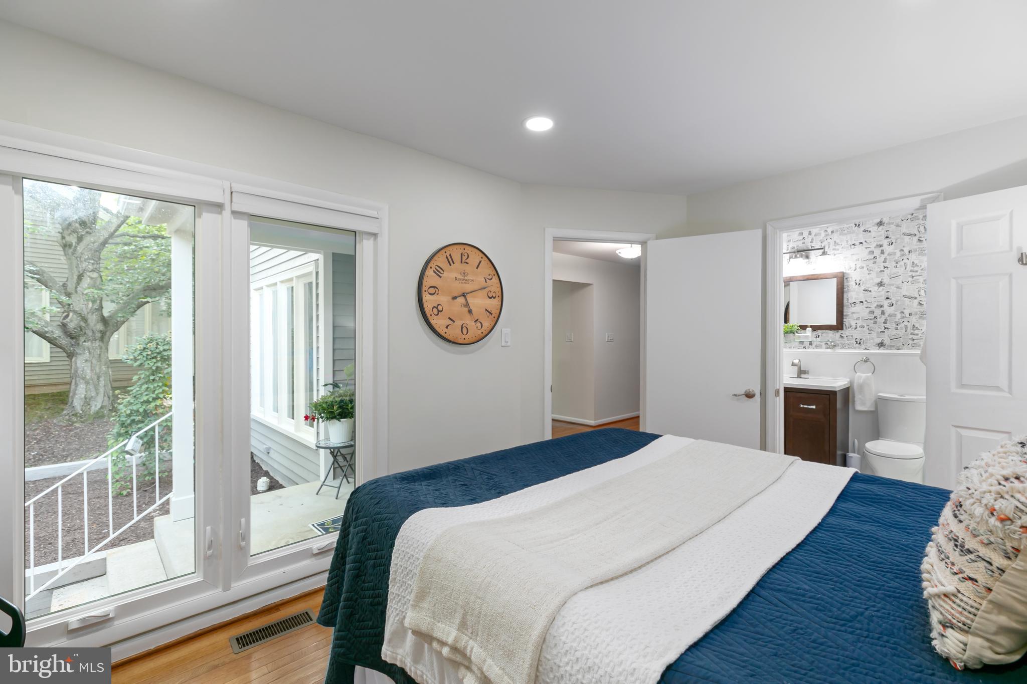 11554 Brass Lantern Court Reston, VA 20194 - Photo 20 of 47 a bedroom with a bed mirror and a window