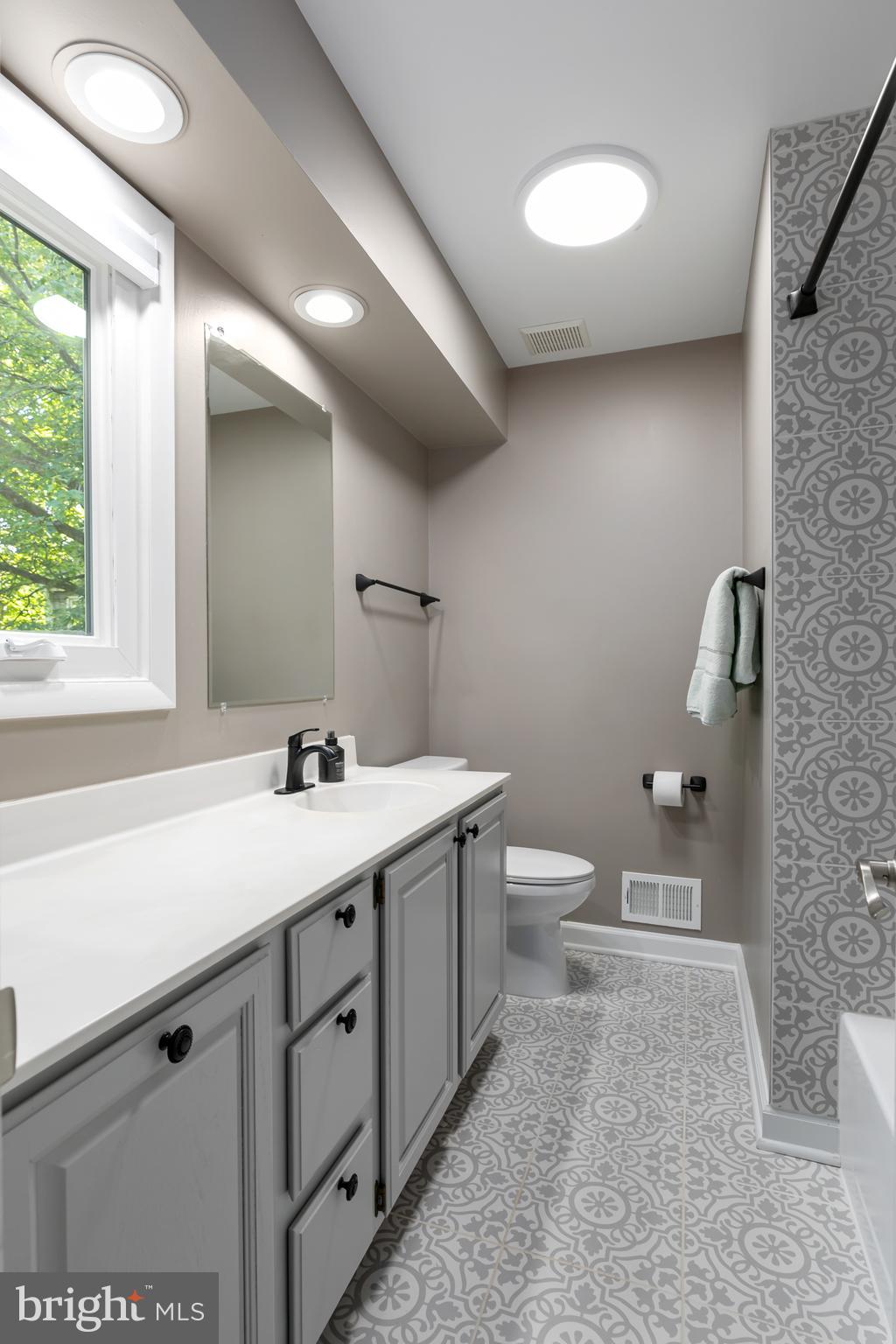 11554 Brass Lantern Court Reston, VA 20194 - Photo 27 of 47 a bathroom with a toilet a sink a mirror and a window