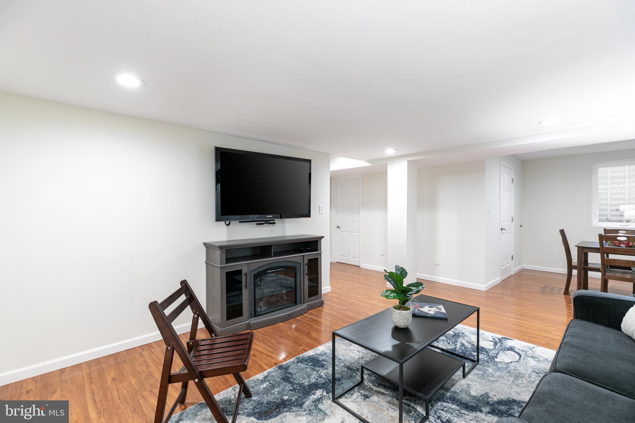 11554 Brass Lantern Court Reston, VA 20194 - Photo 32 of 47 a living room with furniture a flat screen tv and a window