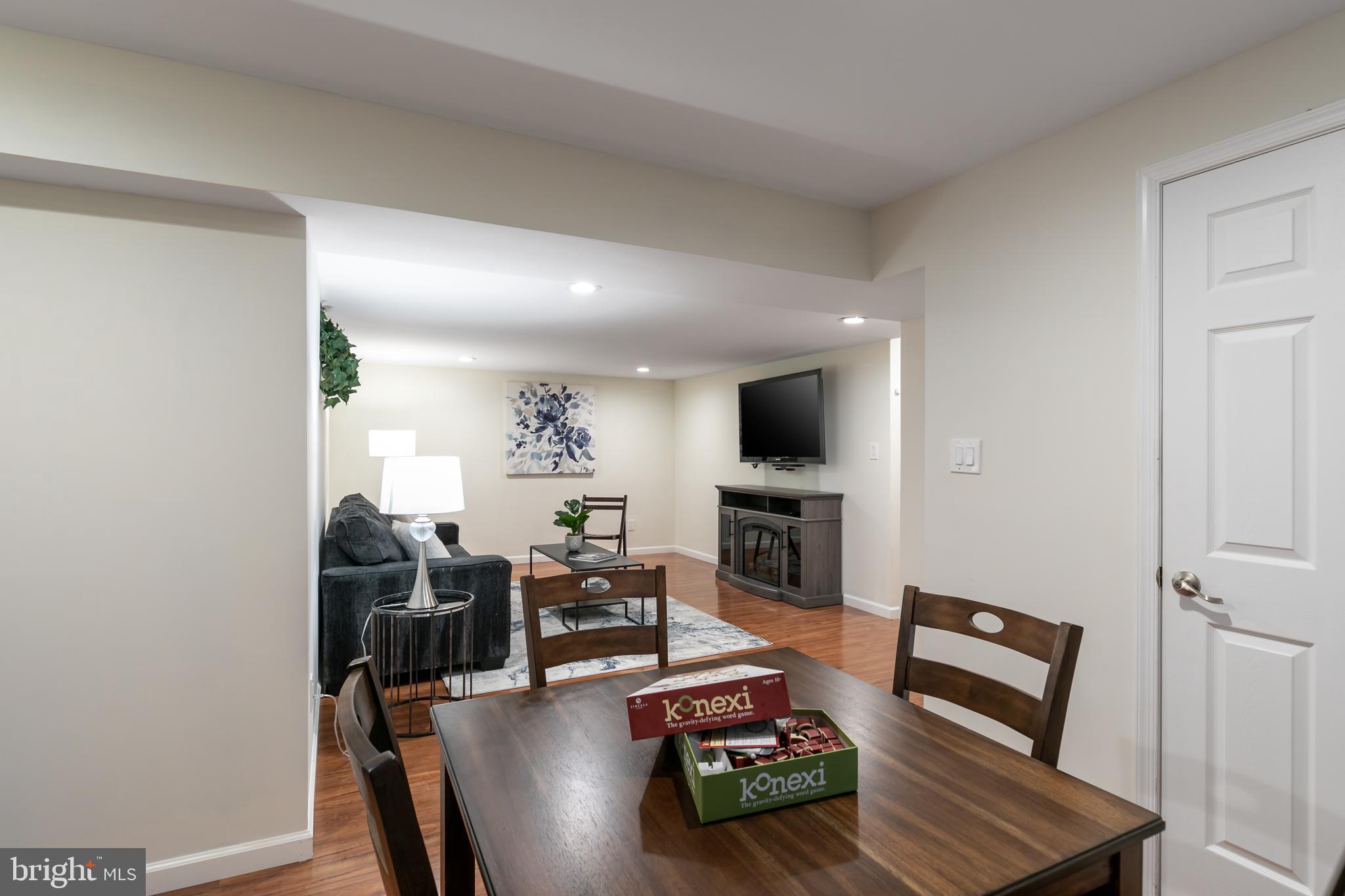 11554 Brass Lantern Court Reston, VA 20194 - Photo 34 of 47 a living room with furniture a fireplace and a flat screen tv