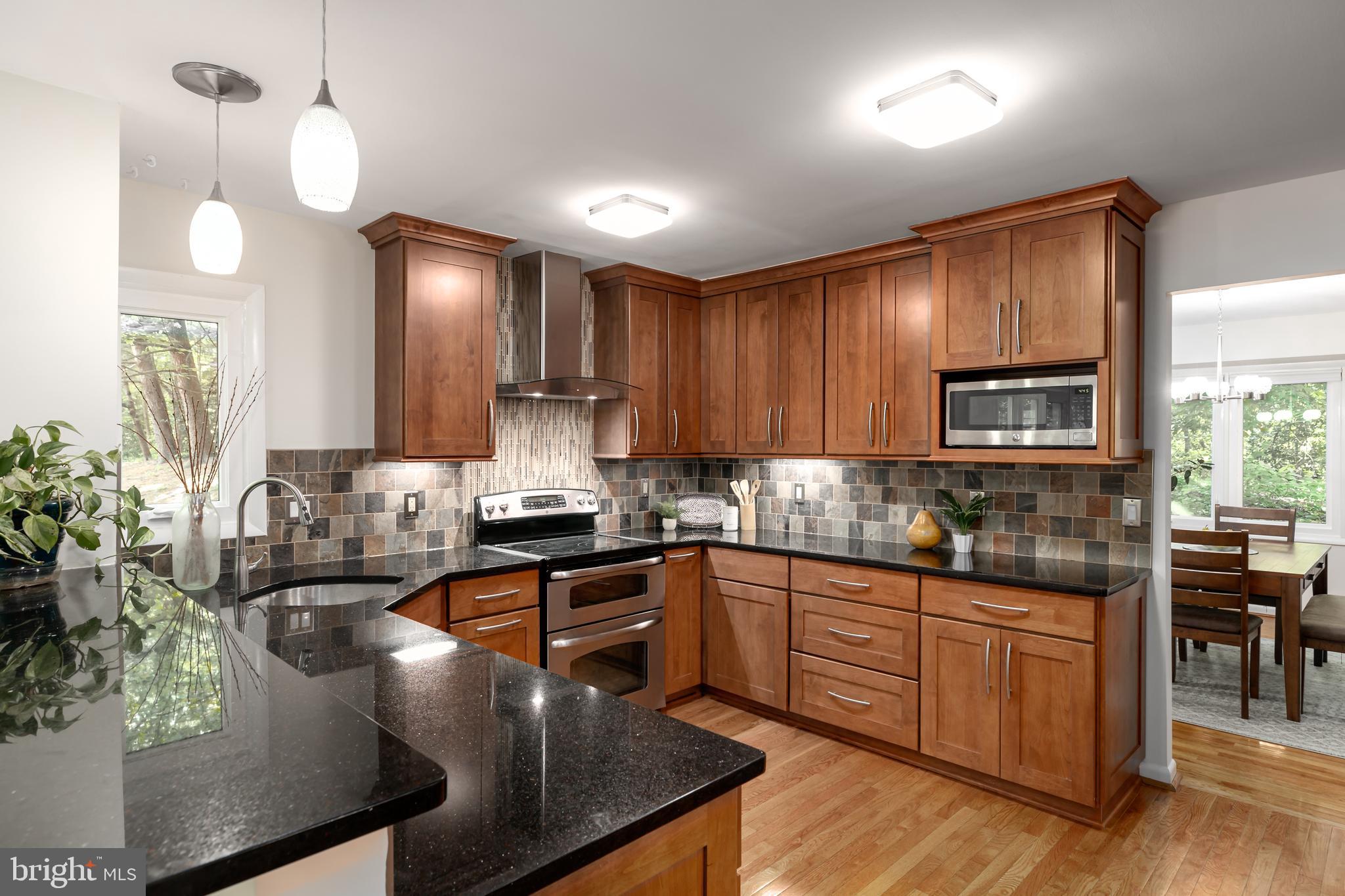 11554 Brass Lantern Court Reston, VA 20194 - Photo 5 of 47 a kitchen with stainless steel appliances granite countertop sink stove and refrigerator