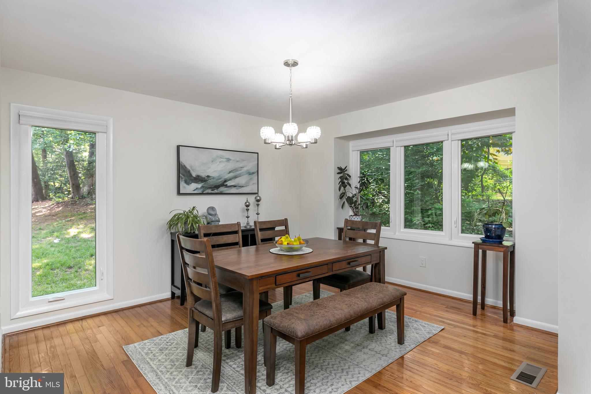 11554 Brass Lantern Court Reston, VA 20194 - Photo 10 of 47 a dining room with furniture a rug and a chandelier
