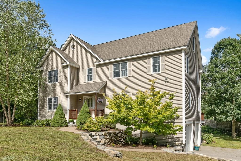 318 Great Road Shirley, MA 01464 - Photo 1 of 36 a front view of a house with a yard and potted plants