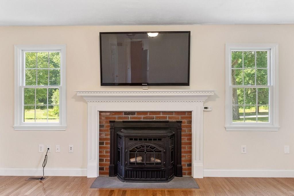 318 Great Road Shirley, MA 01464 - Photo 12 of 36 a living room with a fireplace and a fireplace