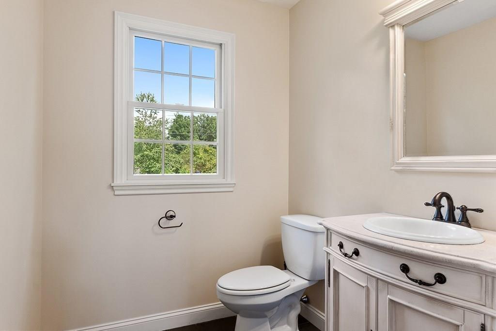 318 Great Road Shirley, MA 01464 - Photo 17 of 36 a bathroom with a sink a toilet and a window