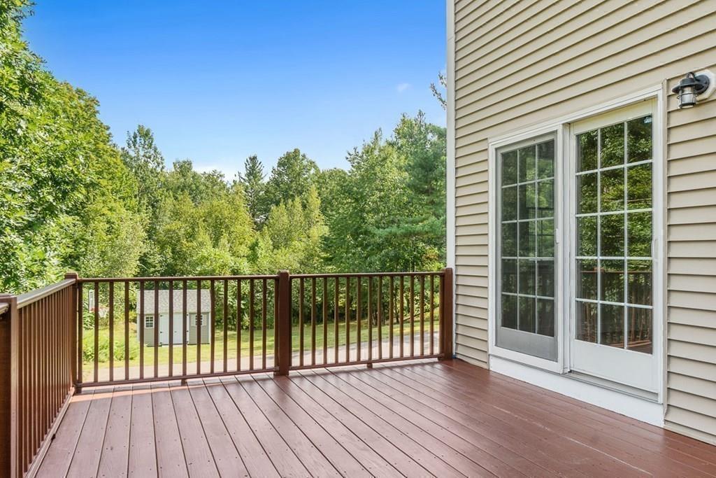 318 Great Road Shirley, MA 01464 - Photo 29 of 36 a view of a balcony with a floor to ceiling window and wooden fence