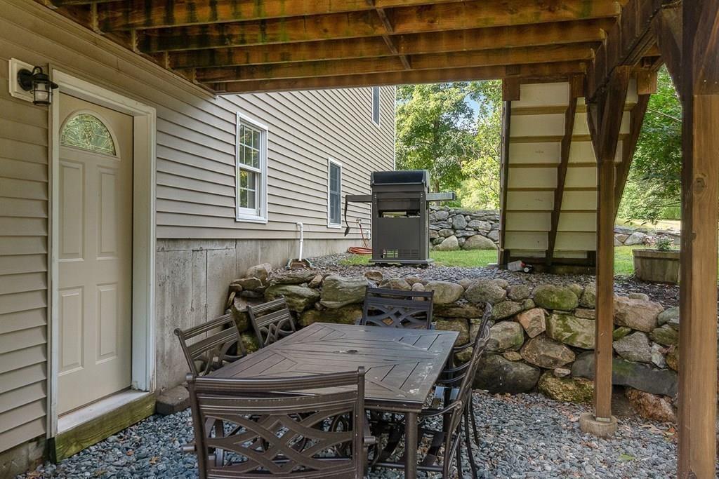 318 Great Road Shirley, MA 01464 - Photo 31 of 36 a backyard of a house with table and chairs