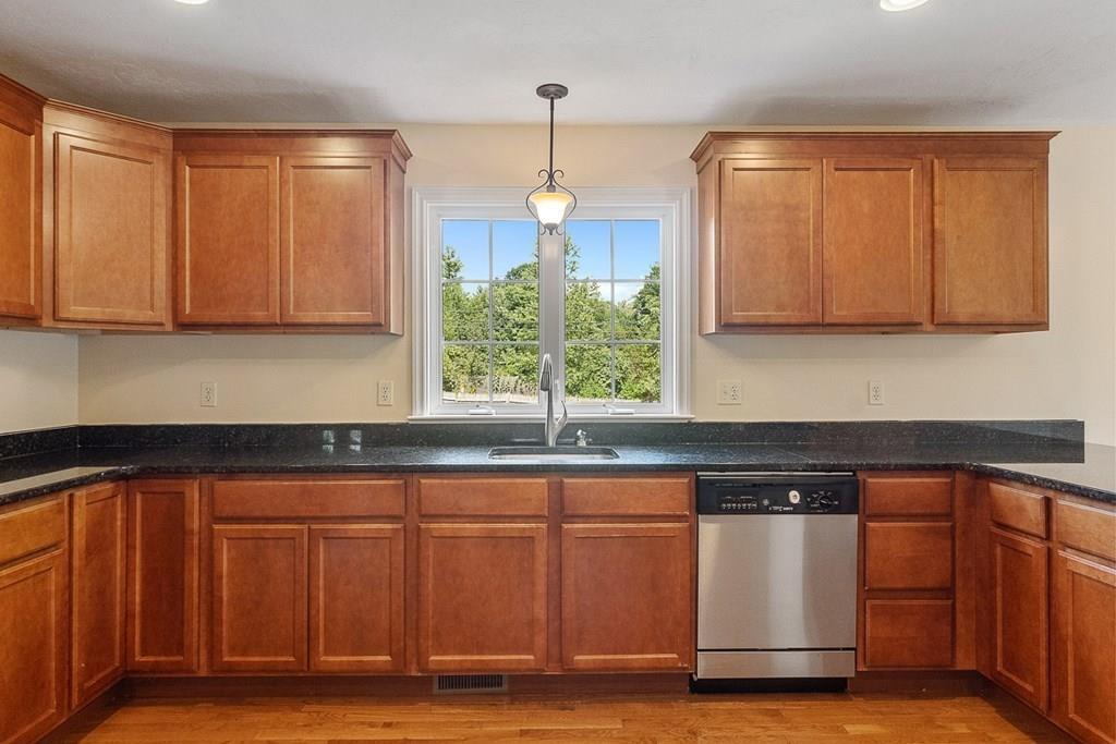 318 Great Road Shirley, MA 01464 - Photo 4 of 36 a kitchen with granite countertop a sink cabinets and wooden floor