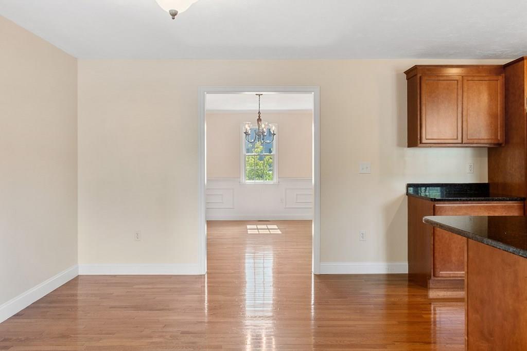 318 Great Road Shirley, MA 01464 - Photo 8 of 36 a view of an empty room with wooden floor and a window