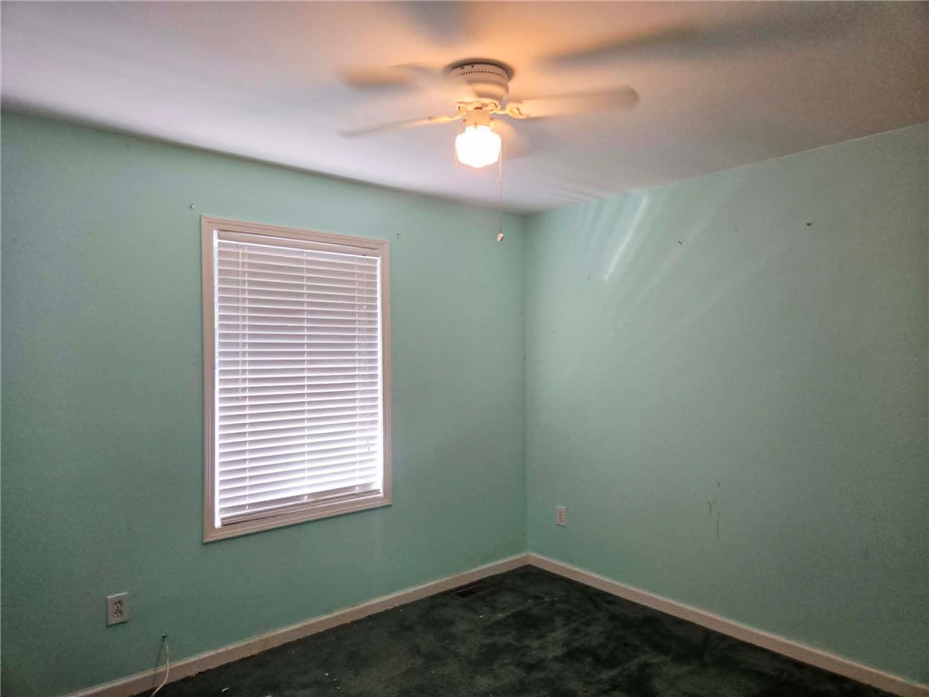 202 Keith Lane Seneca, SC 29678 - Photo 14 of 23 A windowed bedroom with carpeted flooring and a ceiling fan awaits your personal touch.