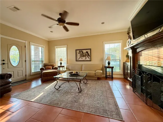 a living room with furniture a window and a flat screen tv