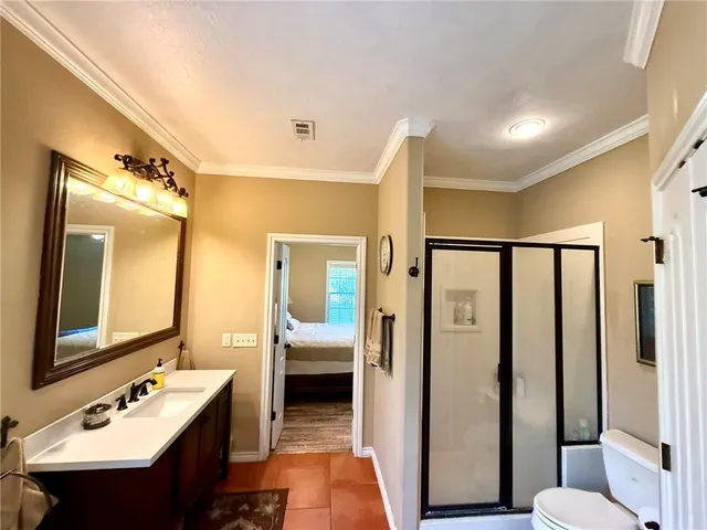 a en suite bathroom with a double vanity sink a mirror and a shower