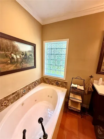 a bathroom with a tub and a window