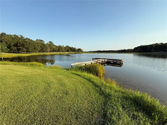 a view of a lake with houses in the back