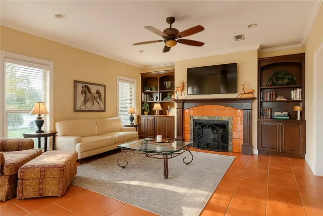 a living room with furniture a fireplace and a flat screen tv